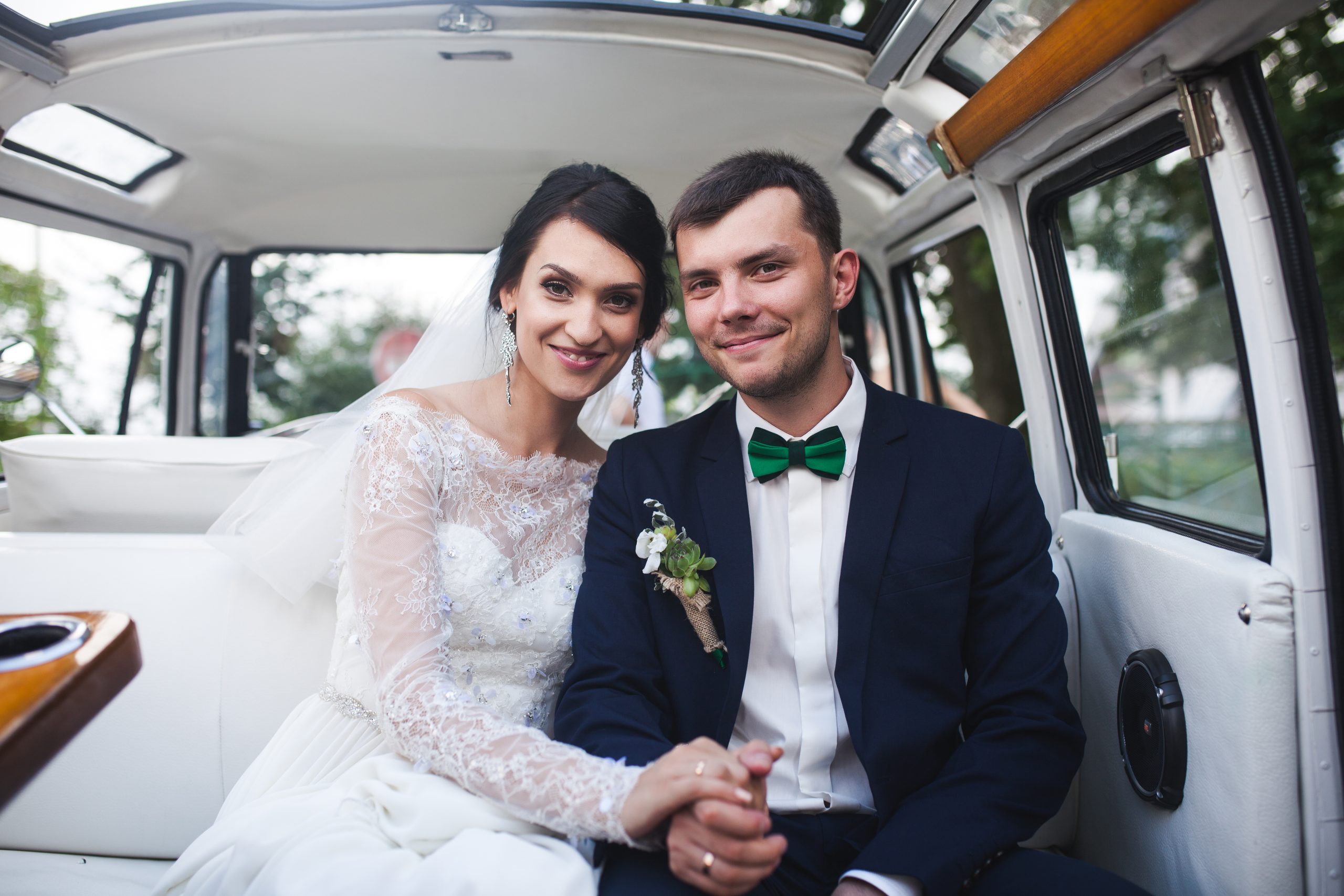 Married couple posing inside a Hamilton Wedding Limo