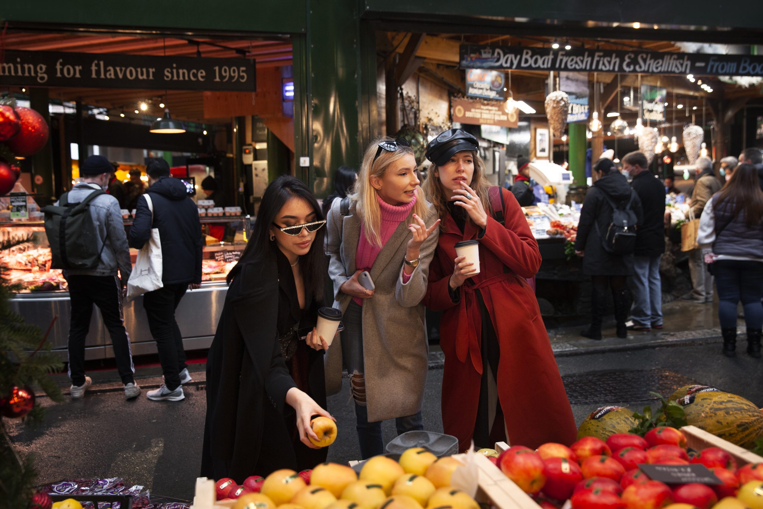 Three women enjoying fall season market in London